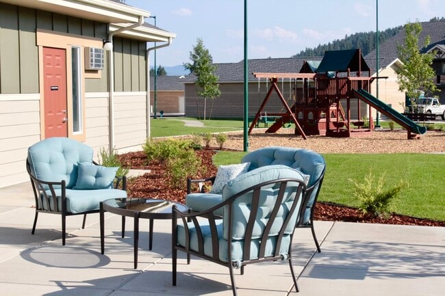 Seating Area With Playground - Riverstone Place Apartments