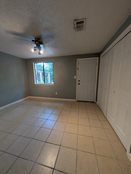 Down stairs bedroom with large closet and back yard exit. - 2228 Sandpiper St