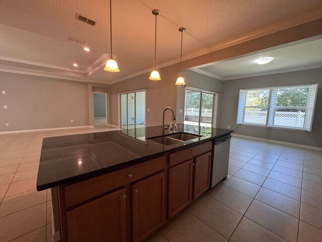 Building Photo - COMING SOON! Beautiful 4BR 3BA Home w/ Screened Lanai & Pond View • Garage Parking • Fenced Yard ...