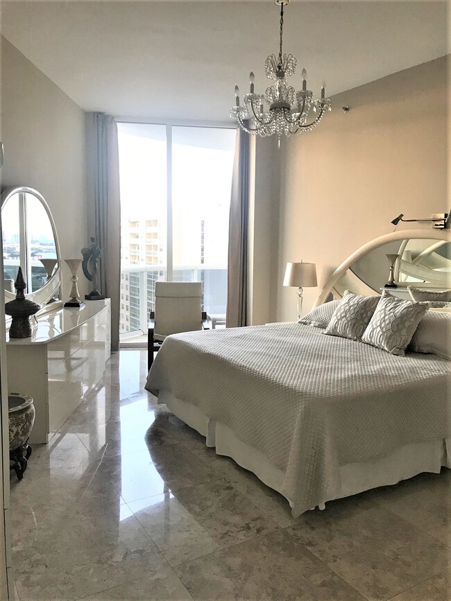 Master Bedroom with king size bed and crystal chandeliers. - 15901 Collins Ave