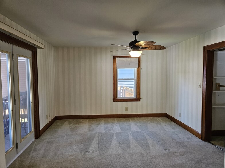 Master bedroom with French doors to the screened in porch - 4047 Mogadore Rd