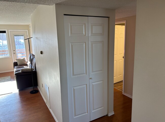 Hall Closet with Living Room to left and Bedrooms to Right - 9725 Independence Dr