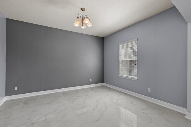 Building Photo - Spacious 6-Bedroom Home Near Lake Nona | 3-Car Garage + Tesla Charger