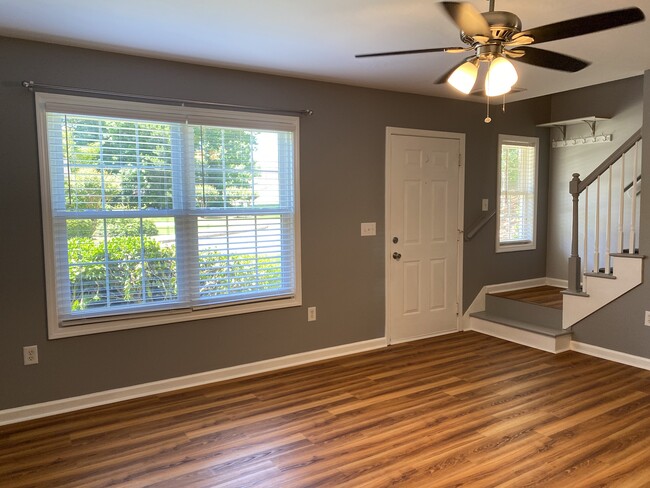 Living Room view of front entrance and stairs - 1305 Cedar Shoals Drive #500