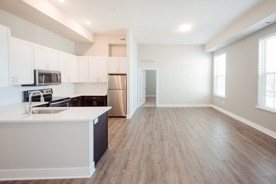 Embrace modern living with this bright and spacious open-concept kitchen and living area. - The Landon at New Albany Park