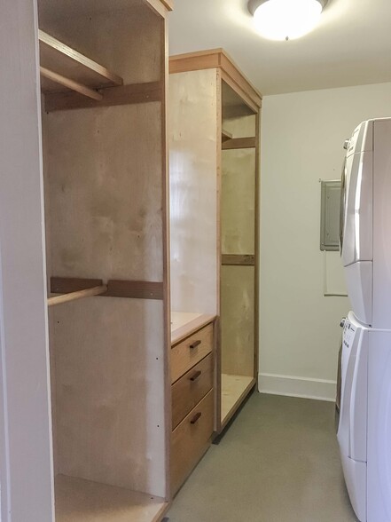 Walk in master closet with custom wood closets and drawers. Front loading washer and dryer. - 527 McDaniel St