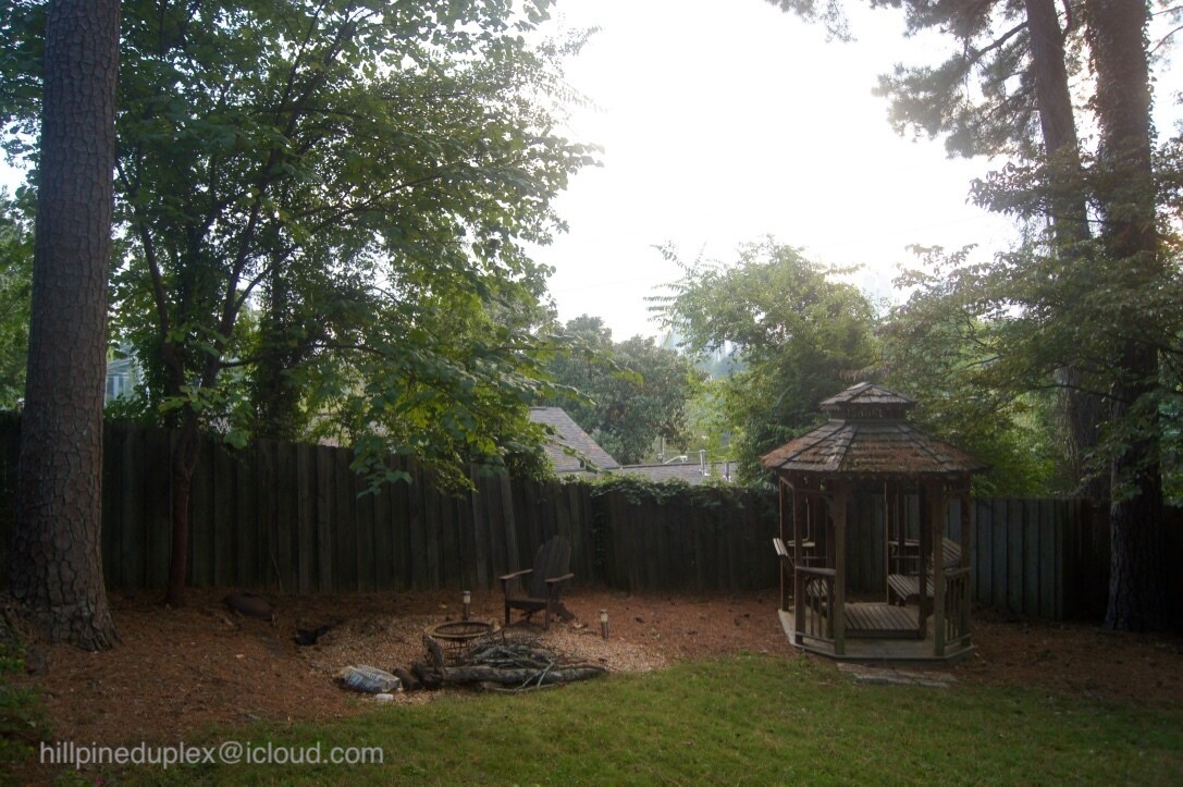 Spacious backyard with gazebo, firepit, patio, and plenty of space for a small garden. - 629 Hillpine Dr NE