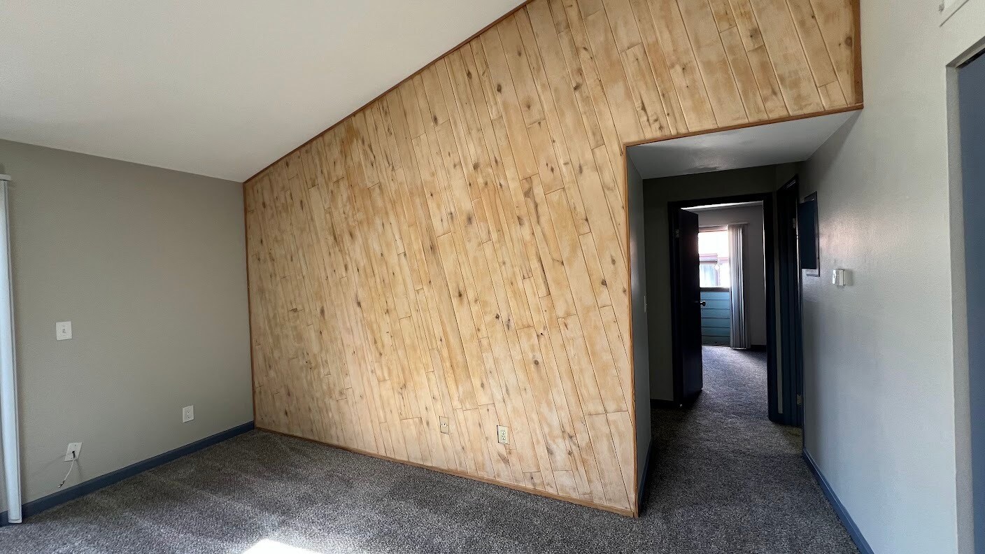 Freshly sanded natural wood wall. - 12063 E Harvard Ave