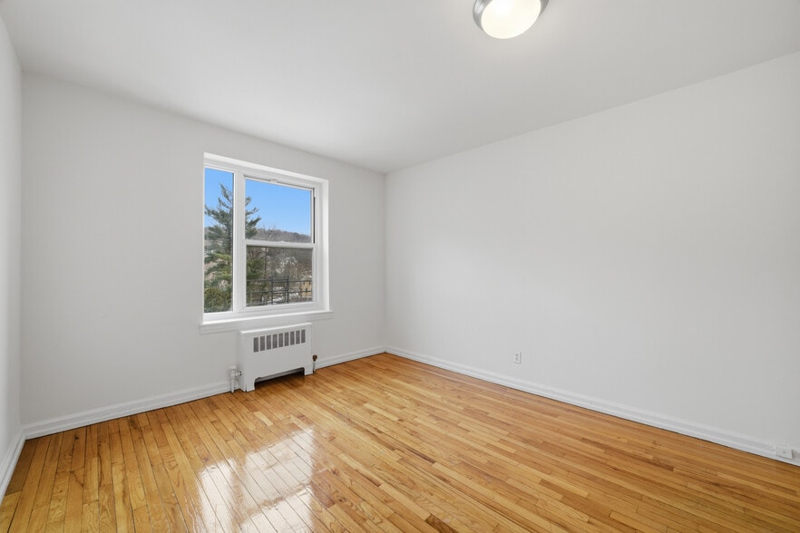 Bedroom featuring hardwood floors. - 555 Broadway