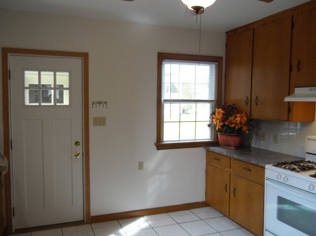 Kitchen side door goes to semi-attached garage and cement patio. Plenty of kitchen cabinet space. - 742 E Ford Ave