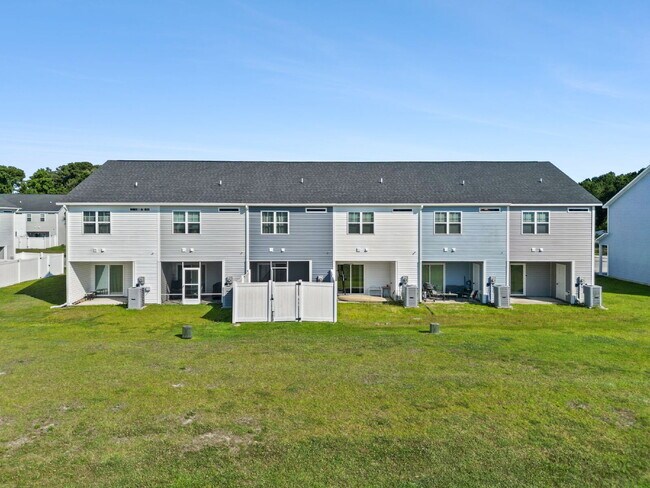 Building Photo - Available Now! Enjoy low-maintenance coastal living in this beautiful 2-bedroom, 2.5-bath townhom...