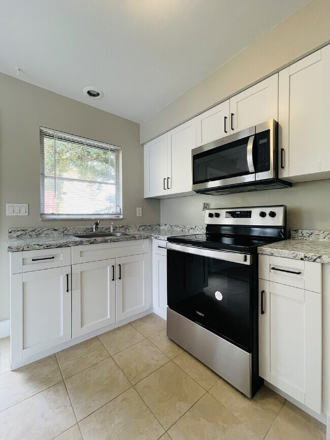 Building Photo - Updated 2-bedroom waterfront duplex with walk-in closets, enclosed Florida room, and canal views ...