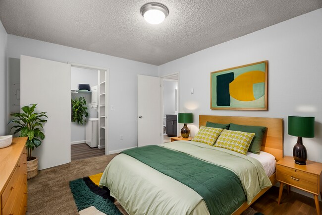Experience tranquility in this chic bedroom retreat, perfect for relaxation. - University Crossing Apartments