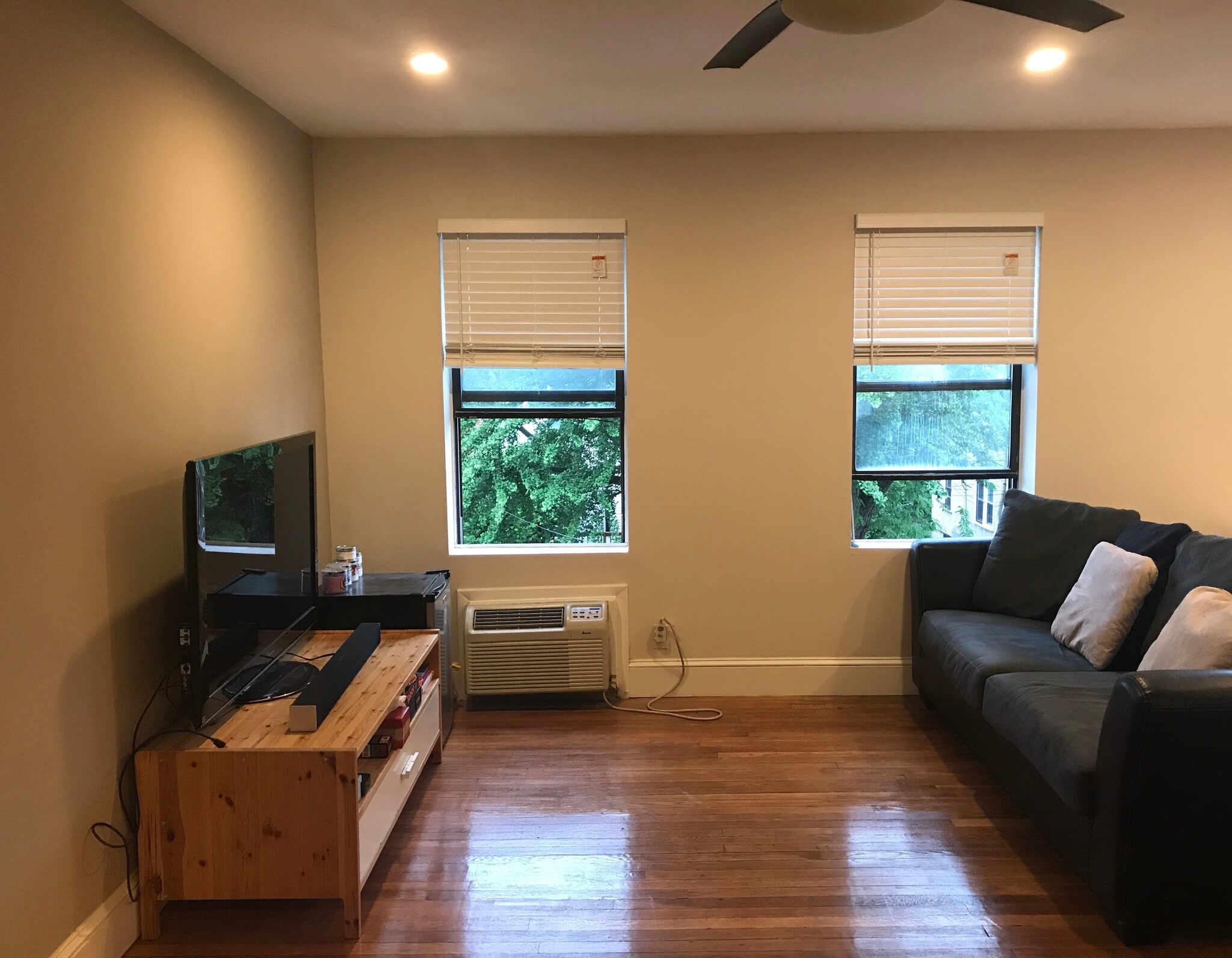 Open floor plan- furnished living room with sofa and entertainment center - 3719 12th St NE