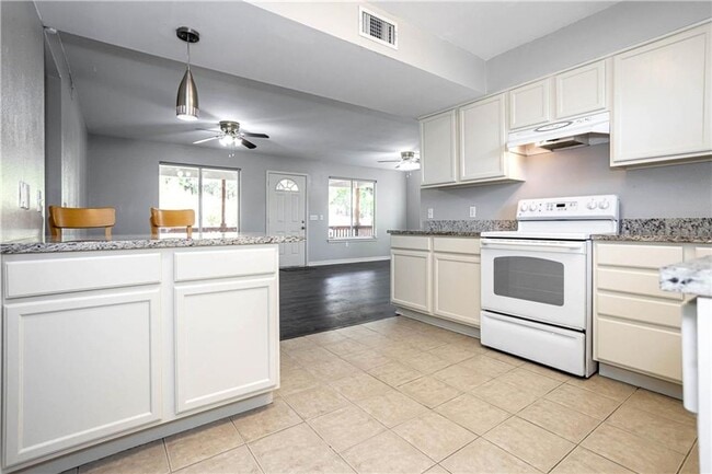 Building Photo - Stunning Renovation - New Hardwood flooring, tile in Kitchen. Granite countertops, breakfast bar