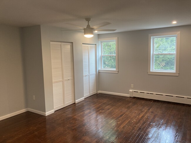 From the 2nd floor hall, you'll enter the primary bedroom. This large room has 3 windows, 2 closets - 2621 E Somerset St