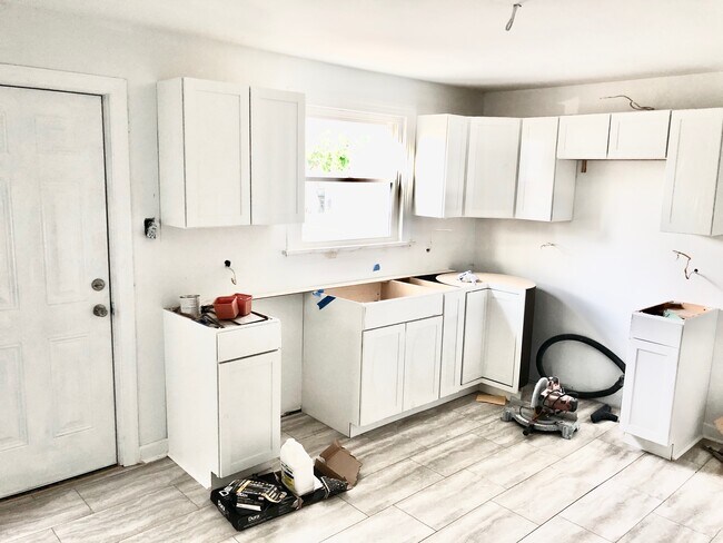 Kitchen - granite counter tops and stainless steel appliances being installed - 1709 Everett St