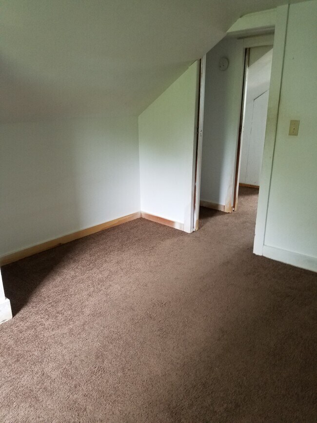 Upstairs Bedroom #1, north wall with entry to top of stairs and Bedroom #2. - 15 Goodrich St