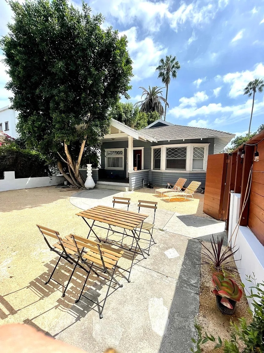 Private front unit with fenced yard, outdoor dining area, and sunny porch surrounded by mature trees - 6000 Carlton Way