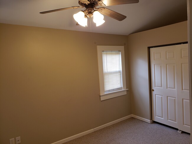 Bedroom 1, vaulted ceiling, spacious closets - 103 W 12th St