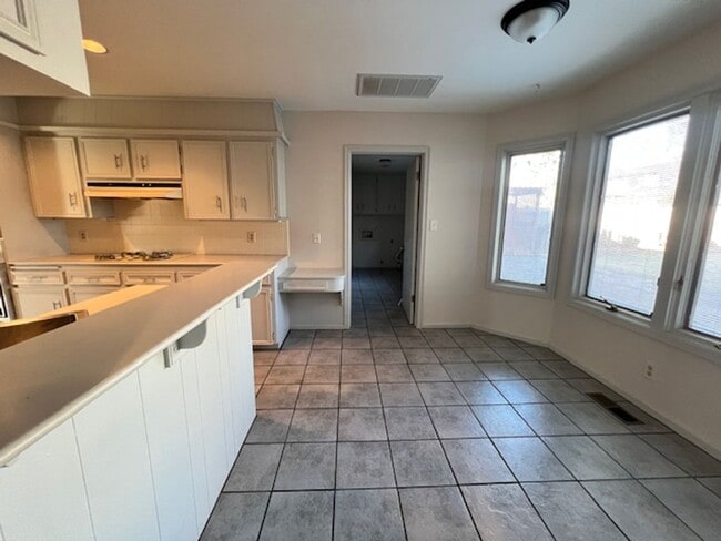 Building Photo - Step into this inviting, sunlit home where space and comfort blend seamlessly