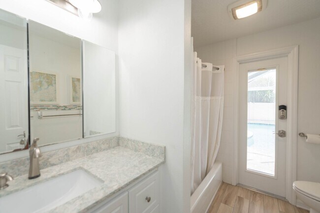 Building Photo - Live the ultimate Space Coast waterfront lifestyle at this stunning beachside canal home in Satel...