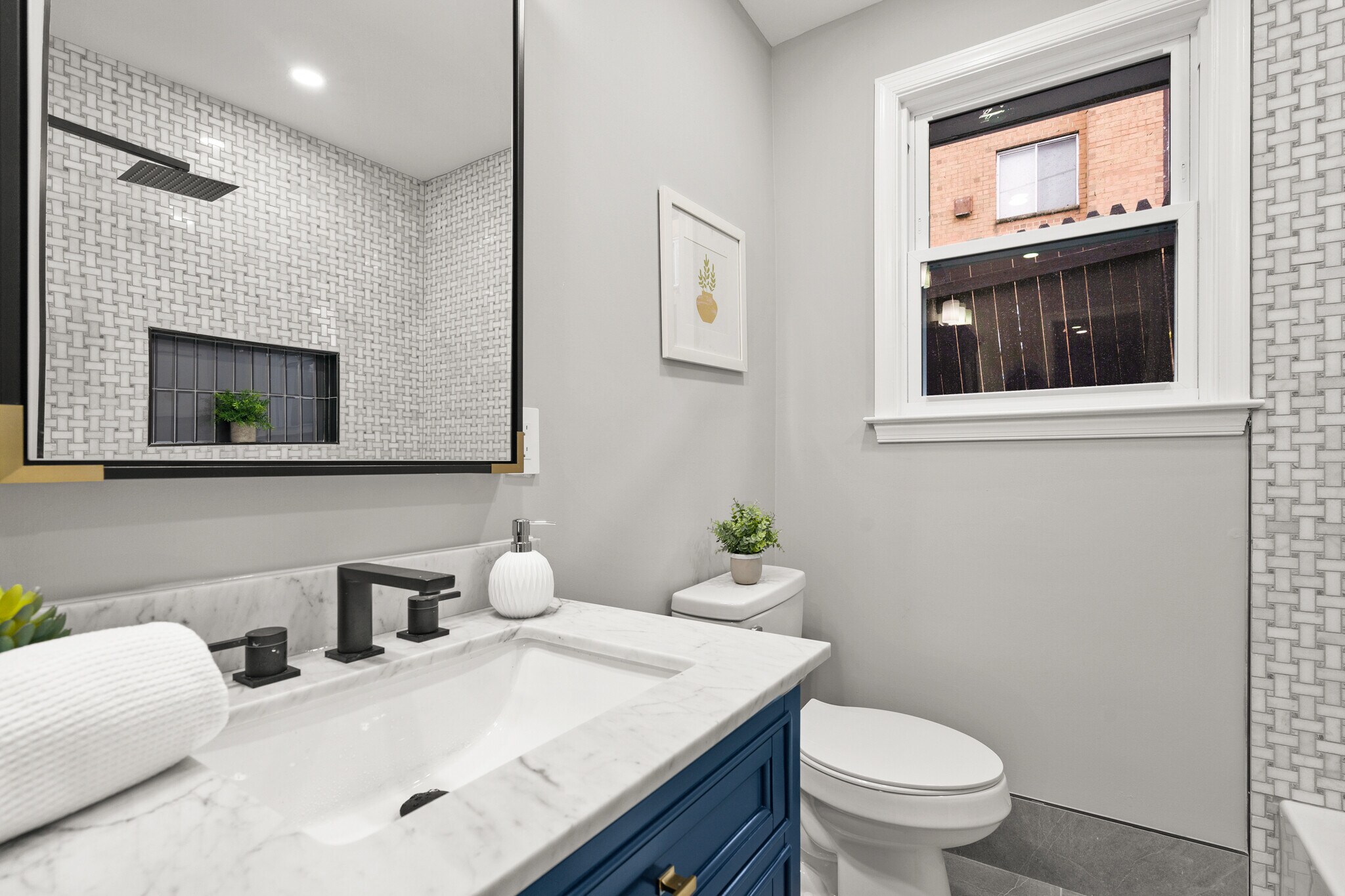 Primary bathroom with double vanity, tub, and toilet - 612 44th St NE