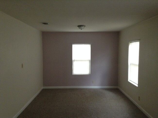 Master bedroom used to be two bedrooms and was combined to be twice as big. The pink wall is now a neutral color. The pink wall is north side of the house and the right wall is the east side and overlooks the backyard. - 24 N K St