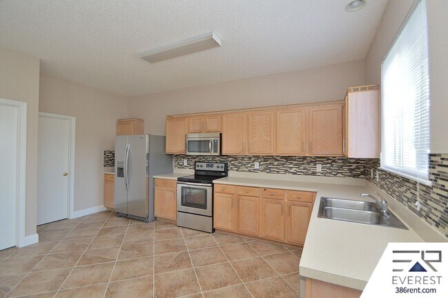 Building Photo - SPACIOUS, FULLY FENCED 4/2.5/2 IN DESIRABLE MATANZAS WOODS