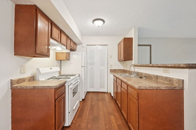 Dooley's Orchard apartment unit showing a kitchen with countertops, cabinets, stove, oven range. - Dooley's Orchard