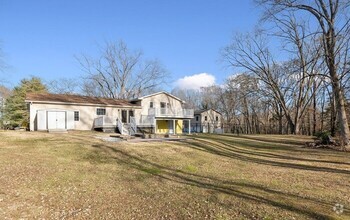 Building Photo - The generous outdoor space stretches over ...