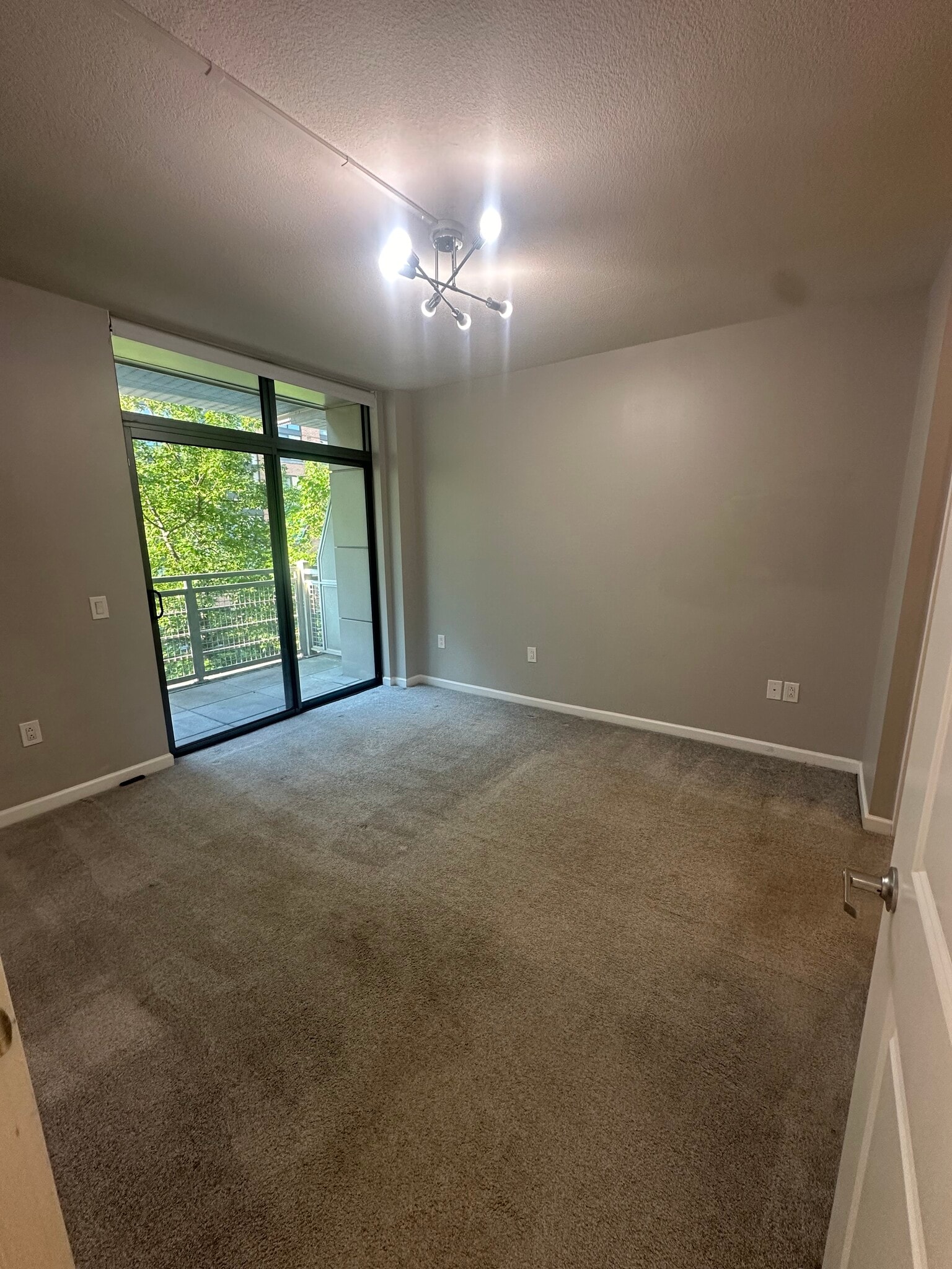 Ignore (other half) - Primary bedroom view from door with living room, balcony in back. - 440 L St NW