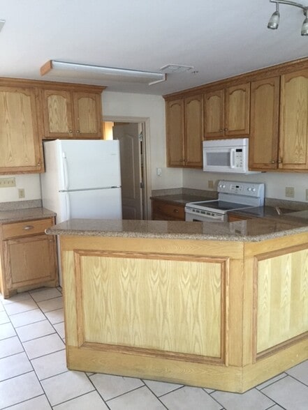 view of kitchen area with lots of cabinet space, granite countertops, and large pantry - 1503 West Fig Avenue