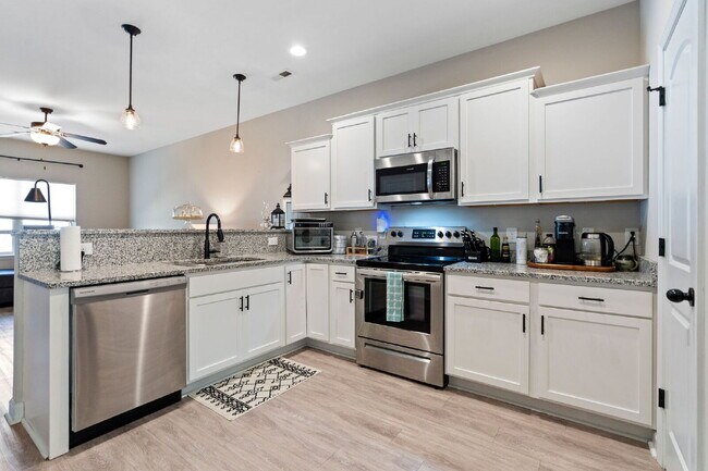 Building Photo - Available Now! Enjoy low-maintenance coastal living in this beautiful 2-bedroom, 2.5-bath townhom...