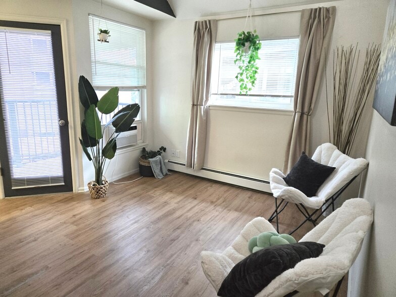 Lounge area with door to south/south-west facing deck. End unit so windows both south and west. - 1830 22nd St
