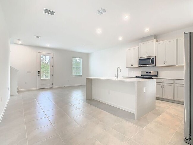 Building Photo - New Luxury Townhome in Celebration with All porcelain tiled floors. Island Village new construction
