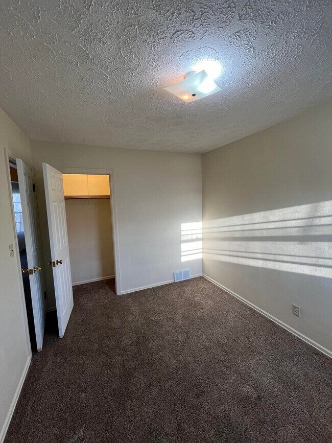 Back bedroom with closet and doorway view. - 2486 21st St