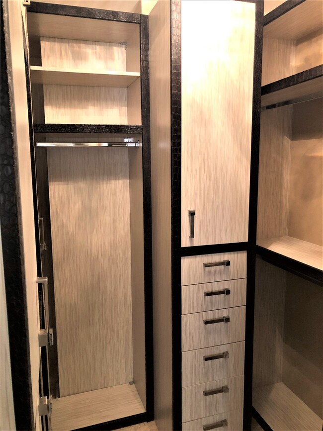 Master Closet with custom cabinets. - 15901 Collins Ave