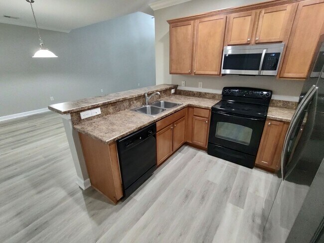 Building Photo - BRAND NEW FLOORING & FRESH PAINT - 3 Bedroom/2.5 Bath Townhome with garage in Wild Wing!