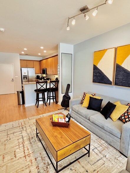 Modern layout with cozy seating, lift-top coffee table & barstool dining. - 3687 4th Ave