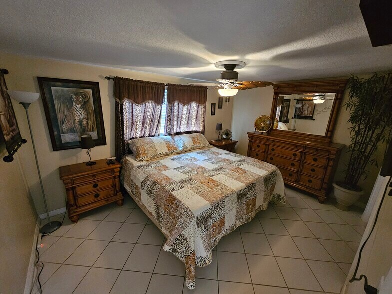 Master bedroom with matching dressers and closet. Mounted TV - 3931 Sail Dr
