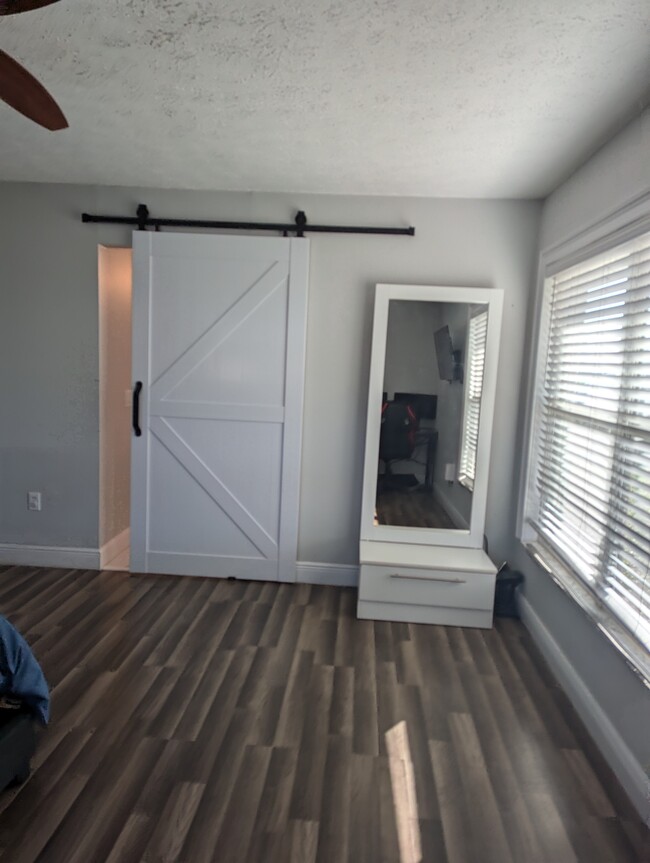 Master bedroom - barn door to access bathroom and closet - 6712 Matanzas Dr