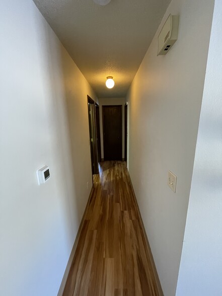 Hallway to both bedrooms and bathroom. - 717 Westgate St