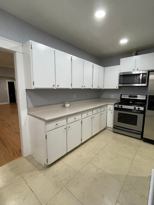 Newly re-done kitchen cabinets with gleaming new brushed nickel hardware and new microwave hood - 271 Del Rey Ave