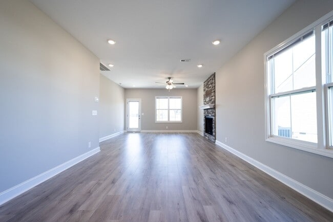 Building Photo - Elegant Home with Stone Fireplace, Kitchen Island and Designer Primary Suite