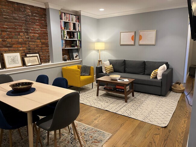 Living/Dining area with exposed brick wall - 192 Hart St