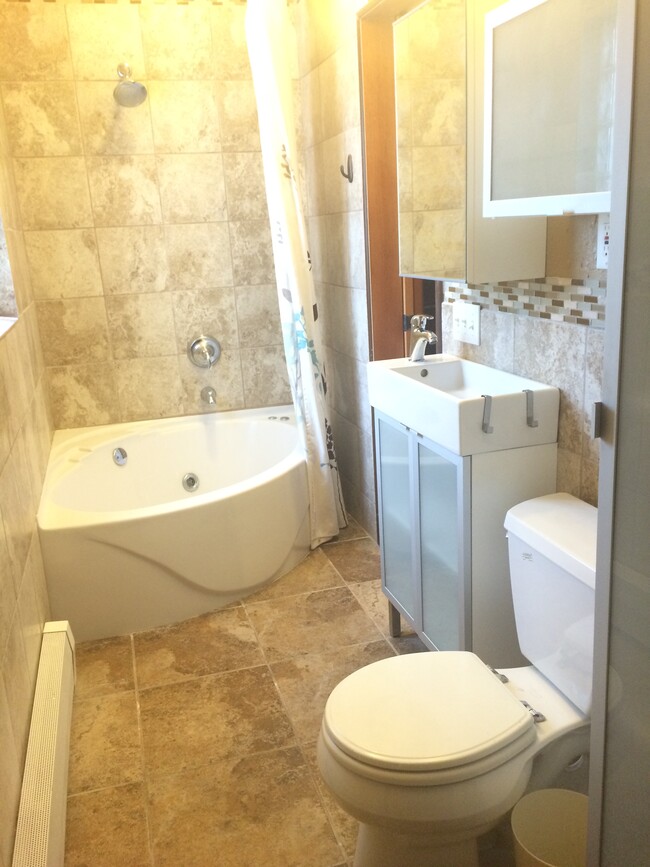 Bathroom, with whirlpool jetted bathtub and pocket door into the kitchen - 3517 19th Ave S