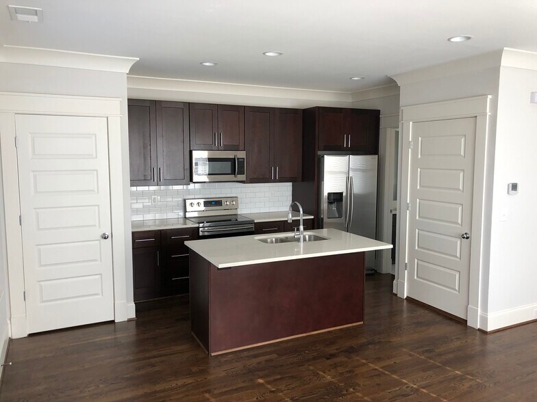 Center island accommodates bar stools for dining - 2121 Roslyn Ave