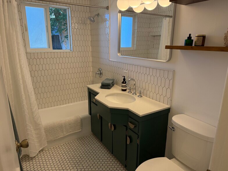 Updated bath, new solid quartz counter on original vintage cabinet - 2101 Laverna Ave