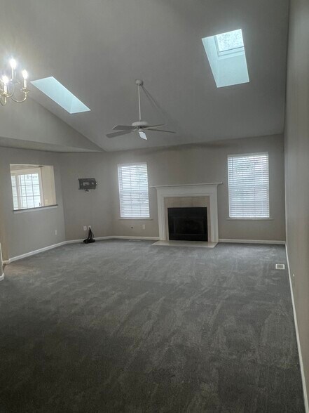 Living room with vaulted ceilings, skylights and fireplace - 36447 N Reserve Cir